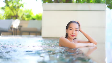 Junge-Sexy-Asiatische-Frau,-Die-Im-Schwimmbad-Genießt-Und-Verführerisch-In-Die-Zeitlupe-Der-Kamera-Im-Vollen-Rahmen-Schaut