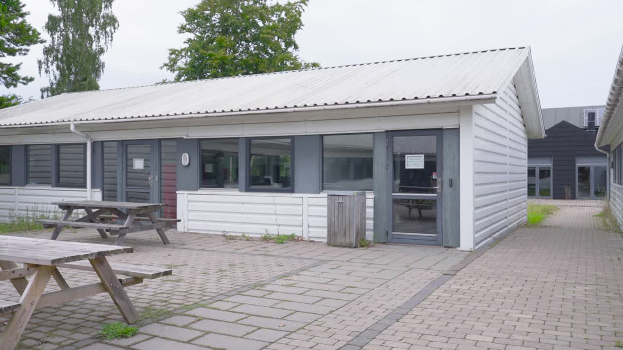 Empty commercial type single storey building and wooden tables, Copenhagen
