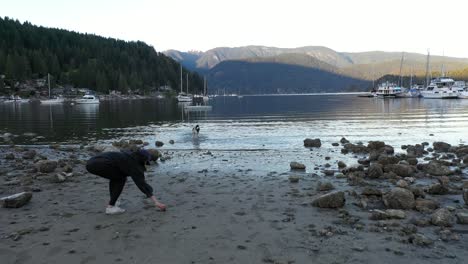 playing with a dog on the beach in deep cove, british columbia