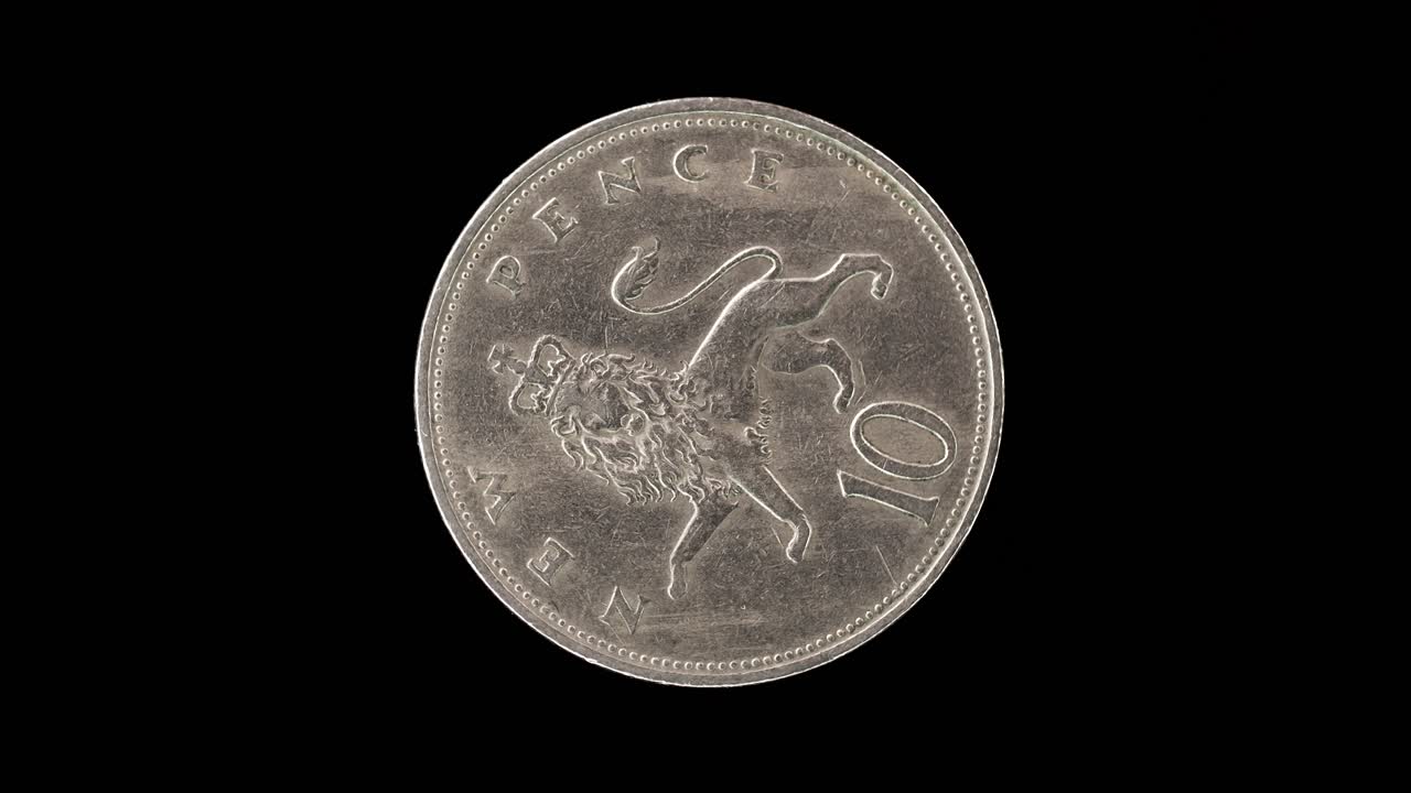 United Kingdom 1968 ten new pence coin reverse with crowned lion passant rotating on black background