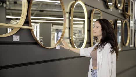 woman shopping for mirrors in a home goods store