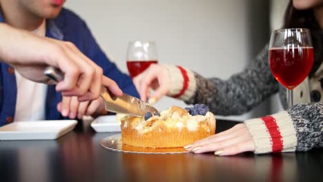 mid-section of couple cutting cake