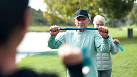 Seniors exercising with resistance bands in a park