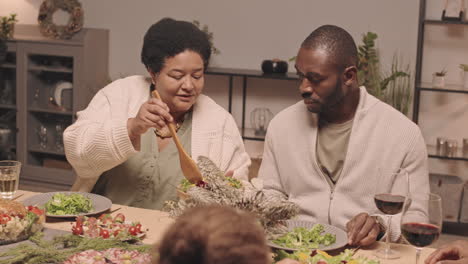 a family enjoys christmas dinner together.