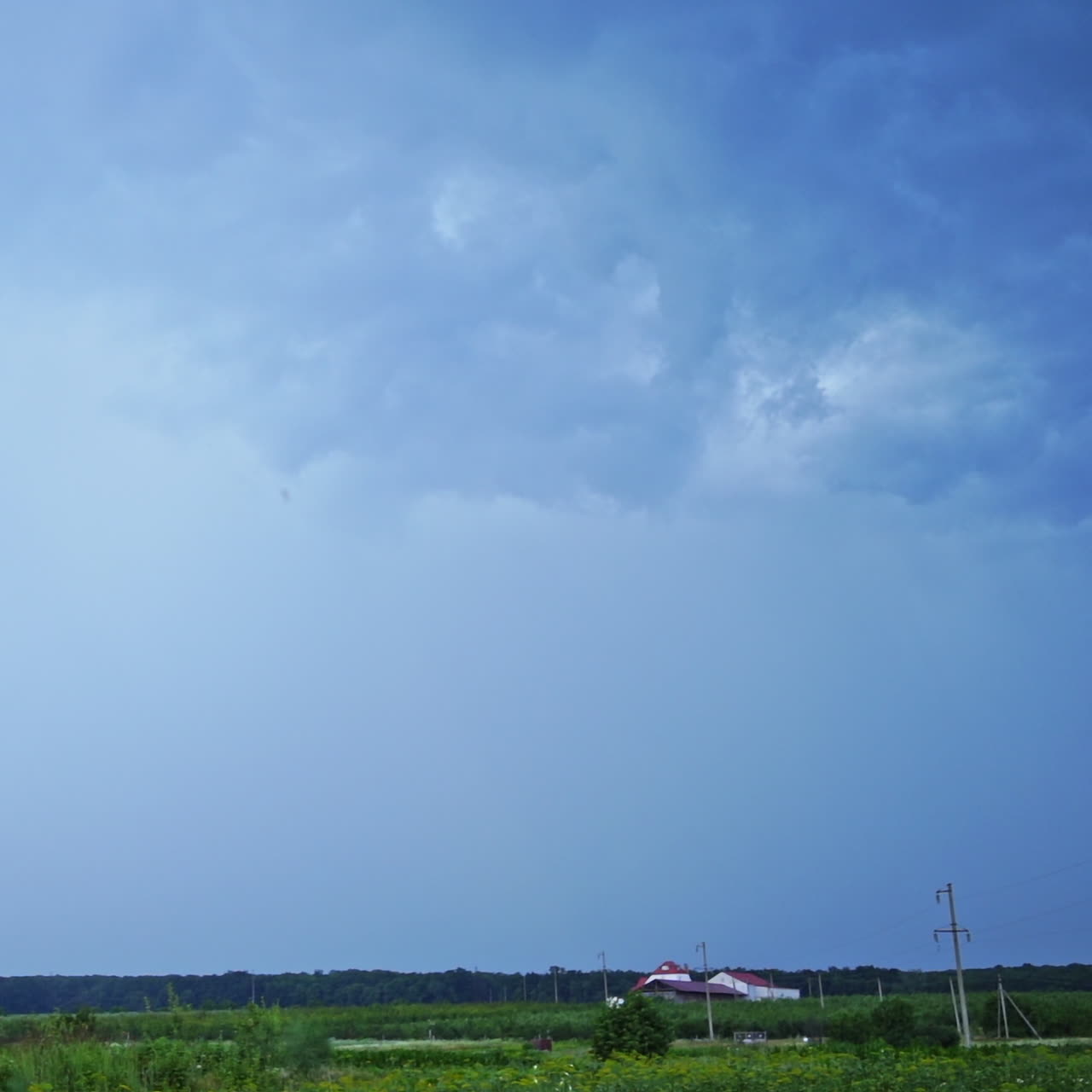Set of beautiful lightning strikes on blue background. Small electrical lightnings in the sky over the green nature in the evening.