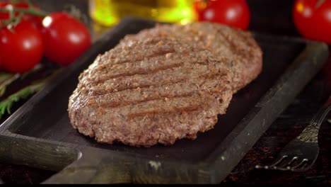 on a wooden board the fried burger rotates.