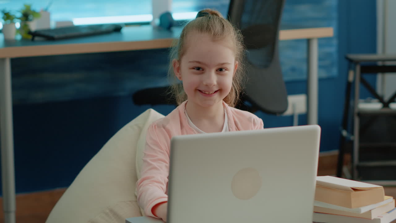 Portrait of young girl working on laptop for school lessons