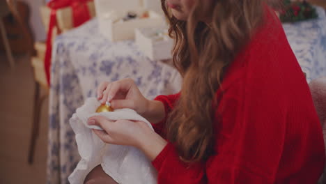 midsection of woman cleaning bauble with cloth