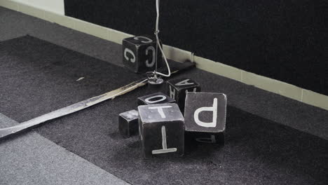 Transportation of steel cubes using a magnet. Boy sits in the excavator simulator and plays with the joystick.