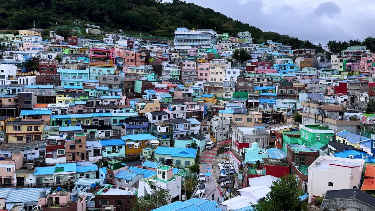 Colorful hillside houses packed closely together in a vibrant urban neighborhood