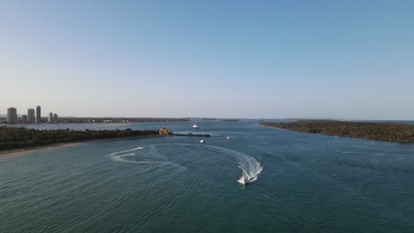 watersports activities in a protected ocean harbor close to a coastal city skyline