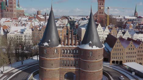 aerial view of the holsten gate in lübeck after snowing