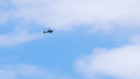 Army-helicopter-flying-overhead-carrying-weapons,-Gaza-war-footage-establishing-shot