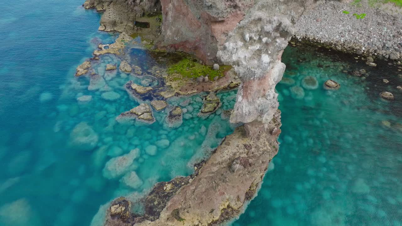 Aerial fly close to clean ocean cliff revealing sea boton in Shakotan Hokkaido Japan, summer nature travel environment