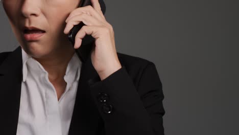 Middle-Aged-Businesswoman-Having-Heated-Phone-Call