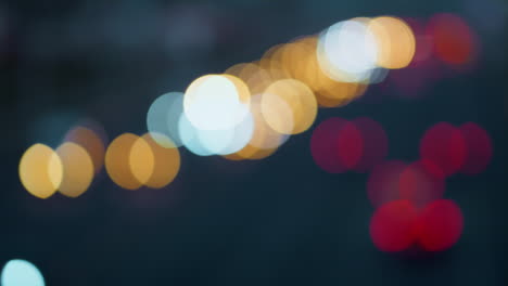 Blurred-headlights-of-moving-cars-night-time.-City-traffic-on-evening-highway.