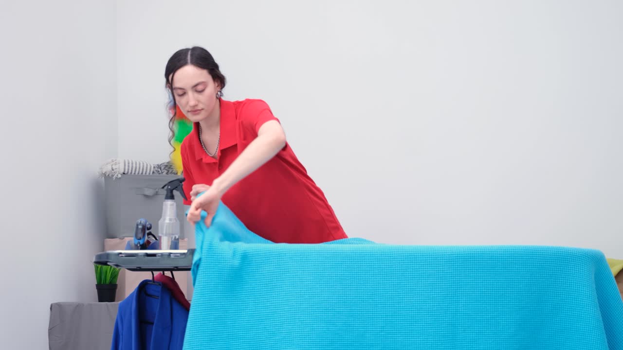 Woman cleaning with blue fabric