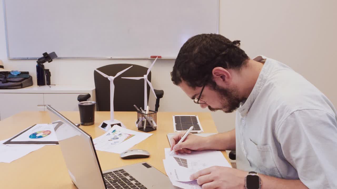 Engineer working on renewable energy models at a desk