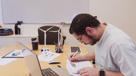 engineer working on renewable energy models at a desk