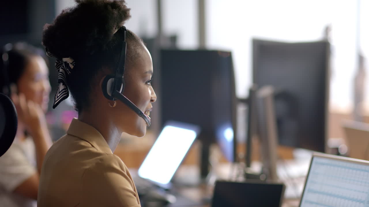 Young African American woman working in a busy office business environment