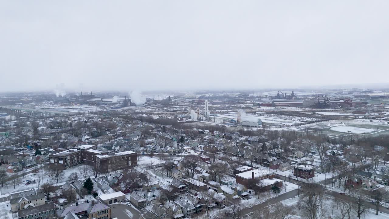 Static aerial shot of factories in Cleveland, Ohio covered in snow.