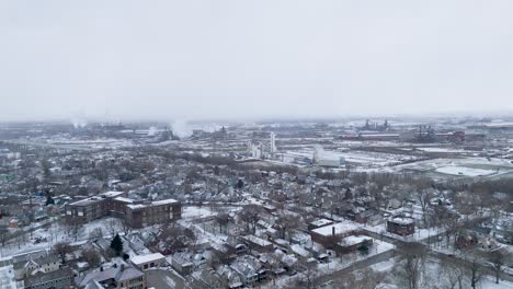 static aerial shot of factories in cleveland, ohio covered in snow.