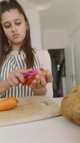 teenage girl peeling carrots