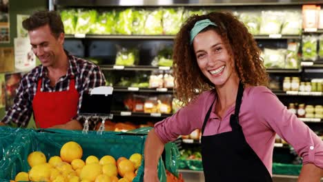 Smiling-female-staff-interacting-with-colleague-in-organic-section