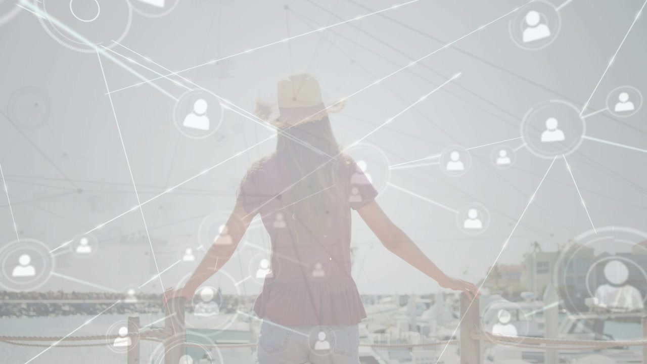 Female teen leaning railing while tech nodes starting at torso expanding over marina mapping links
