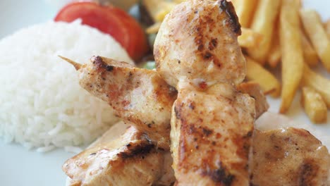 grilled chicken skewers with rice and french fries