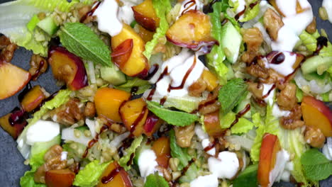 grain salad with nectarine rotating on plate