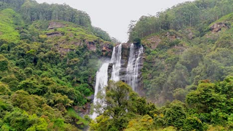 witness the breathtaking beauty of ramboda waterfalls in nuwara eliya, sri lanka, captured from a stunning aerial perspective.