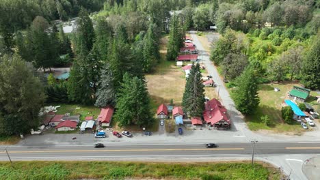 Panning-aerial-view-of-Baring,-Washington's-main-strip-off-the-highway