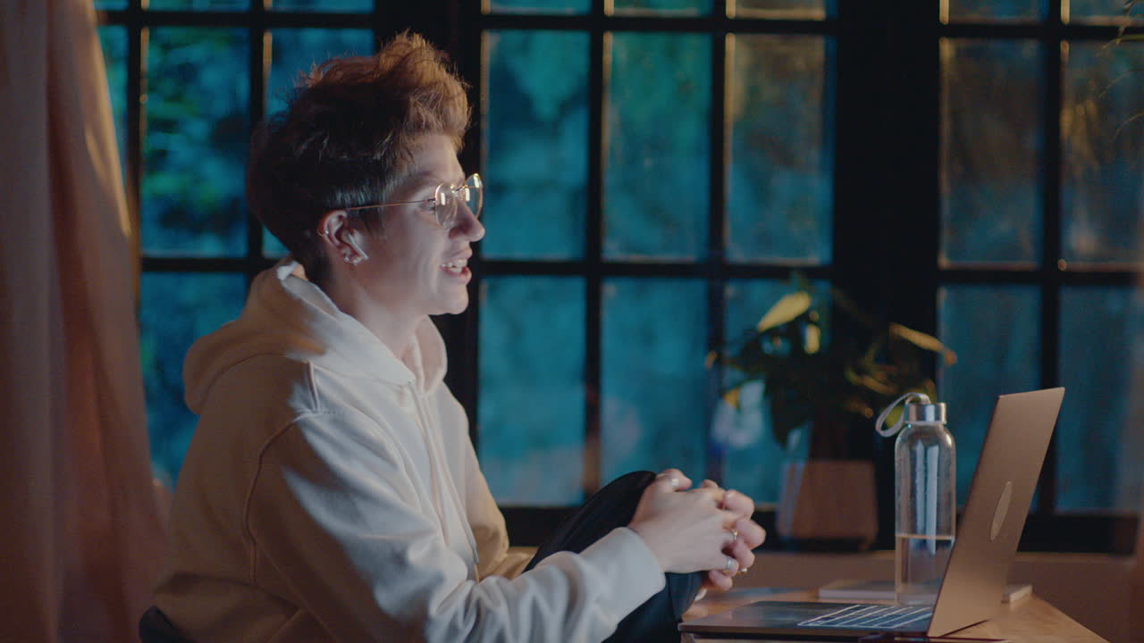 Cheerful Woman Chatting on Video Call in the Evening at Home