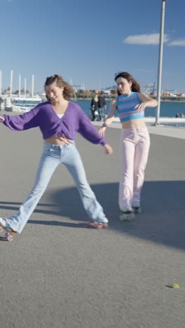 young woman roller skating with a friend by the waterfront