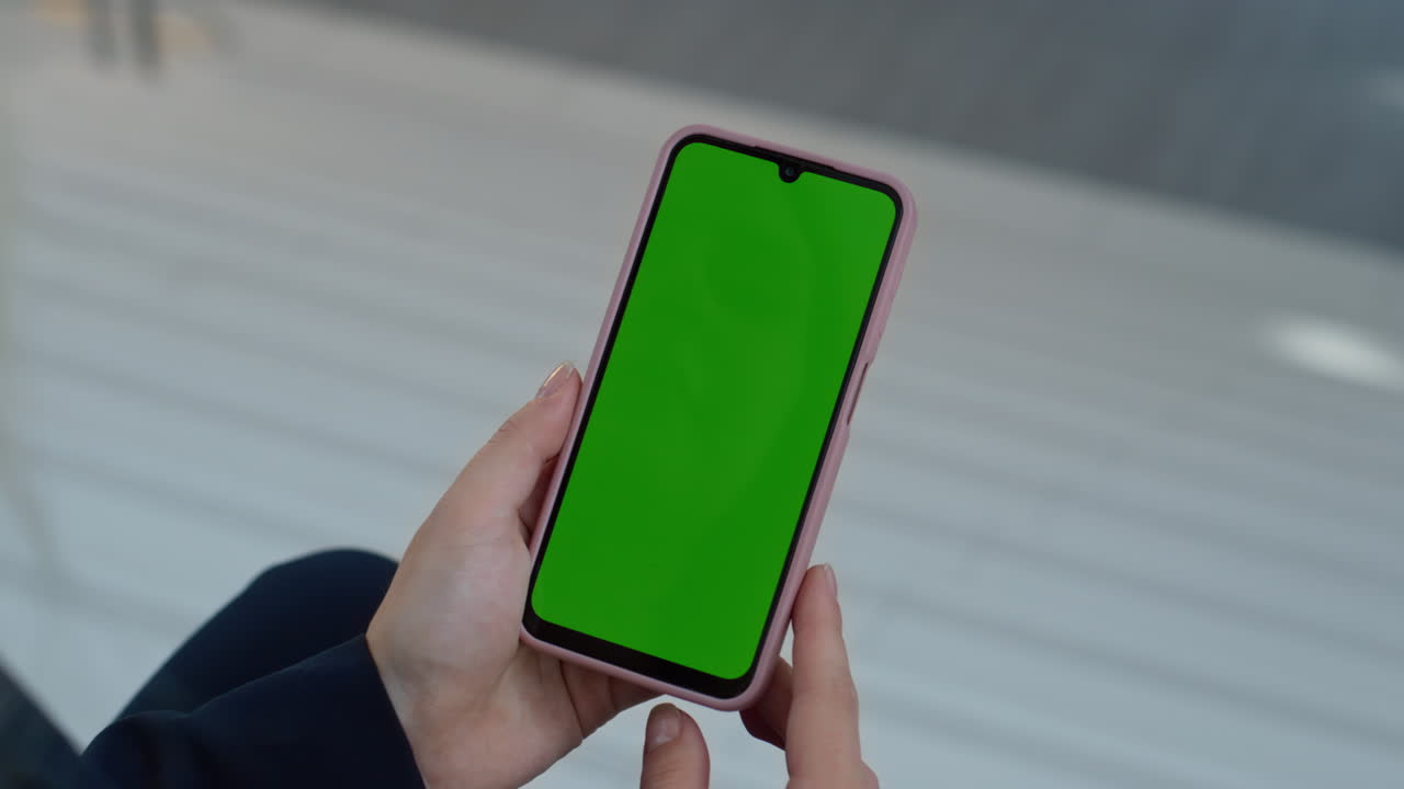 Fingers scrolling green screen smartphone at apartment closeup. Unknown woman