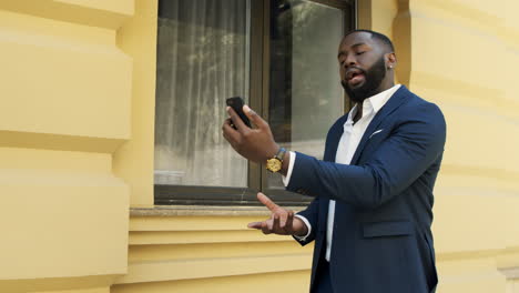 angry business man having video call outdoor