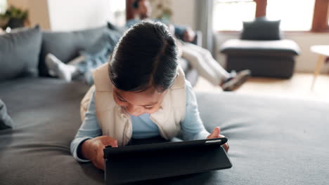 tablet, sofa and happy child in home living room