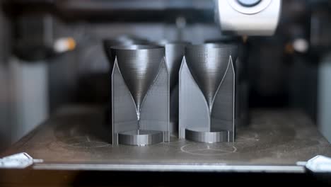 a 3d printer manufactures rocket wings for drone equipment in a workshop. this innovative, cost-effective tech reshapes warfare, enabling scalable production of expendable drones for modern combat.