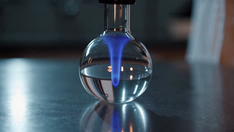 blue flame in a round bottom flask