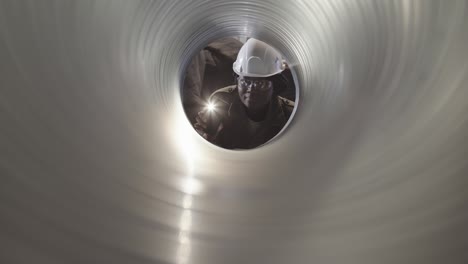 view of female worker through pipe