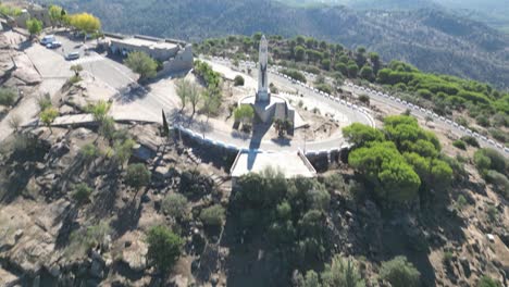 aerial reveal of virgin mary statue at our lady of cabeza basilica andalusia spain