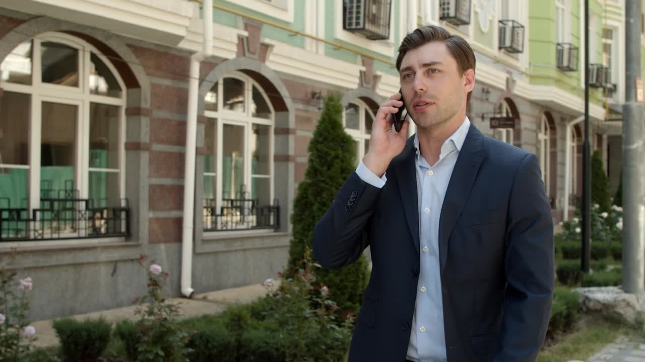 Business man talking phone at street. Businessman discussing business outdoor