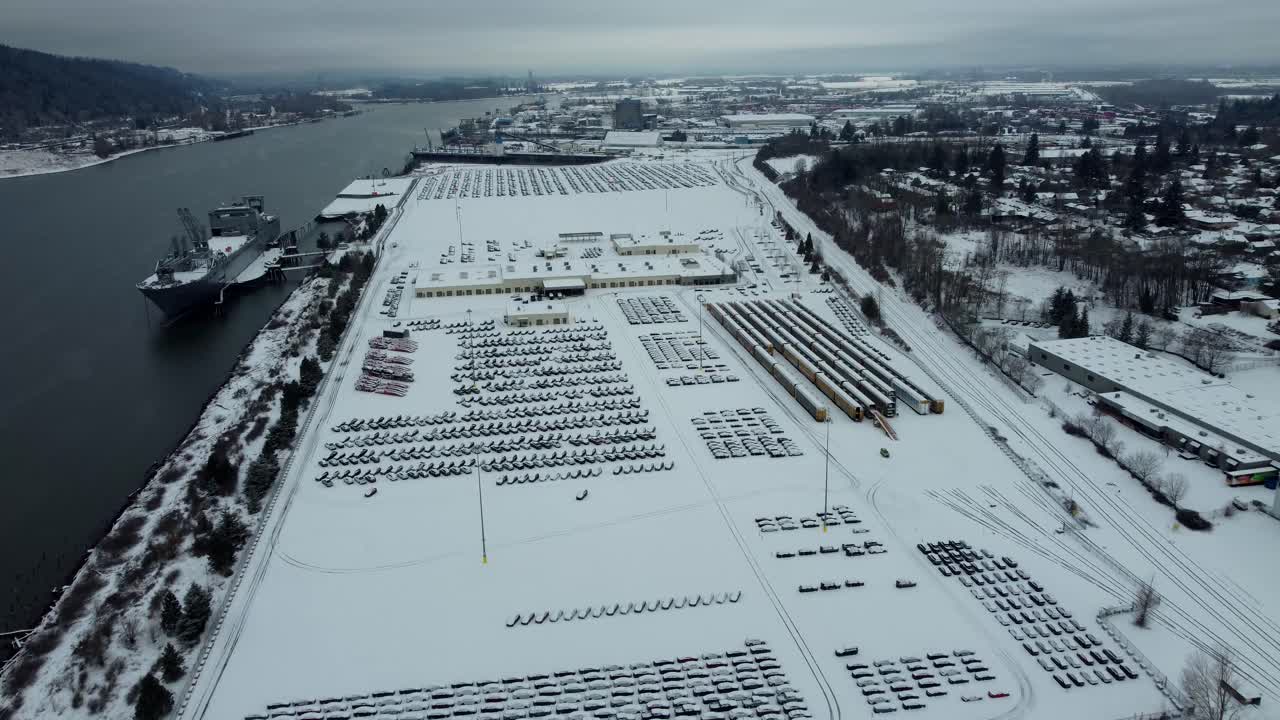 US, Oregon, Portland, St Johns, 2025-02-14 - Drone view of the car unloading lot where they take cars off the boat and load them onto trains, in the snow