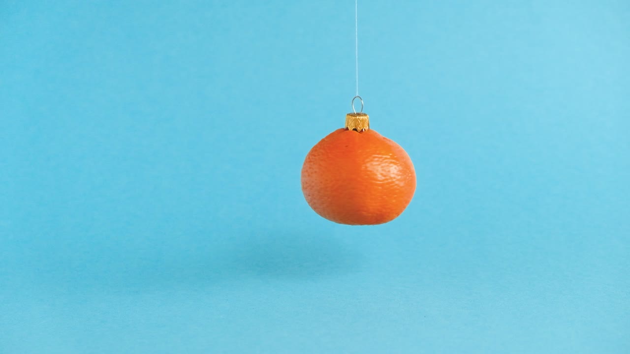 오렌지 탄저린 과일로 만든 날아다니는 크리스마스 장난감. 최소한의 새해 개념. 레비테이션