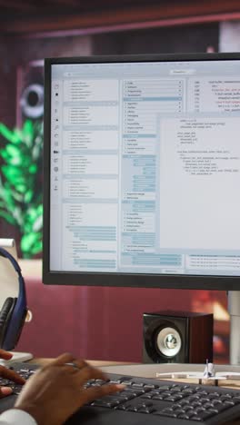 Vertical video Close up of person using coding application to write and test code