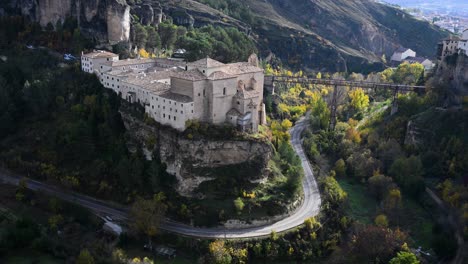 cuenca, spain - a high-angle view of the parador de cuenca and the san pablo bridge crossing the huecar gorge, surrounded by the stunning colors of autumn foliage.