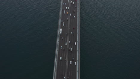 Car-Traffic-on-Bridge-going-into-the-City-in-Istanbul,-Turkey,-Aerial-Birds-Eye-tilt-up-view