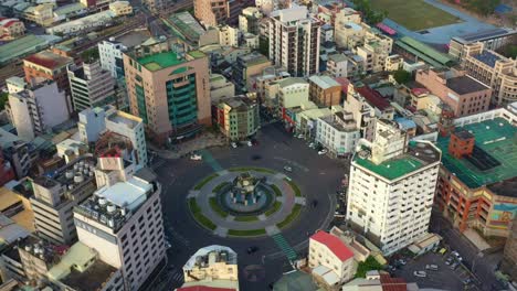 aerial view of a city roundabout with surrounding buildings