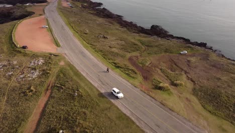 4K-30FPS-Car-driving-on-coastal-road-near-a-rocky-beach-in-South-America